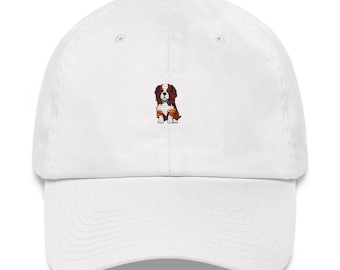 May include: White baseball cap with an embroidered image of a brown and white dog wearing a green bandana.