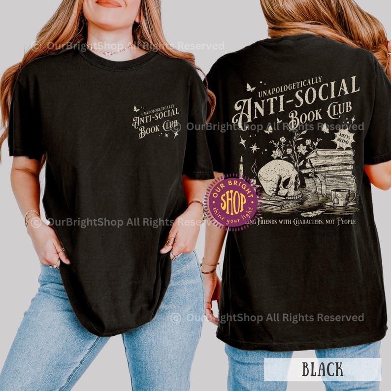 May include: Black t-shirt with the text "UNAPOLOGETICALLY ANTI-SOCIAL BOOK CLUB" on the front and back. The back graphic includes a skull, books, and a teacup. The shirt is a comfortable, casual style.