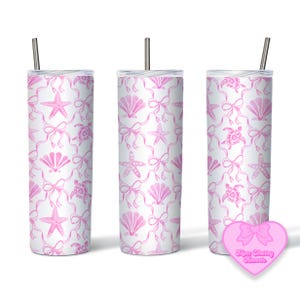 May include: Three stainless steel tumblers with pink watercolor designs of seashells, starfish, and turtles with pink bows. The tumblers are on a white background.