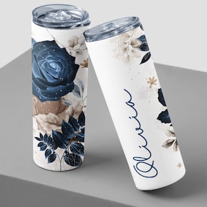 Tilted view of custom tumblers, Olivia name in cursive, stylish floral and leaf design for gifts.
