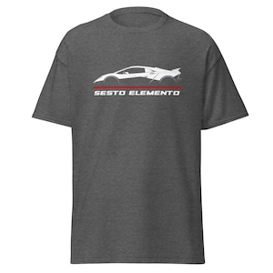 May include: A dark heather grey t-shirt with a white silhouette of a Lamborghini Sesto Elemento sports car and the text "Sesto Elemento" in white letters.