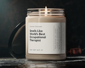May include: A beige scented soy candle in a glass jar with a black lid. The white label reads: Scented Serenade, Smells Like World's Best Occupational Therapist, KEEP THAT SHIT UP, Hand-poured soy candle, 9 oz, 50-60 hours burning time.