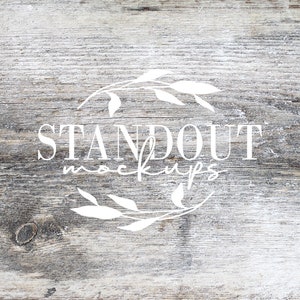 May include: A white wooden background with a white floral wreath and the text "STANDOUT MOCKUPS" in the center.