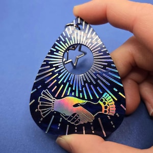 May include: A white ceramic mug with a black handle and the text "But First, Coffee" in a black, handwritten-style font. The mug is on a white surface.