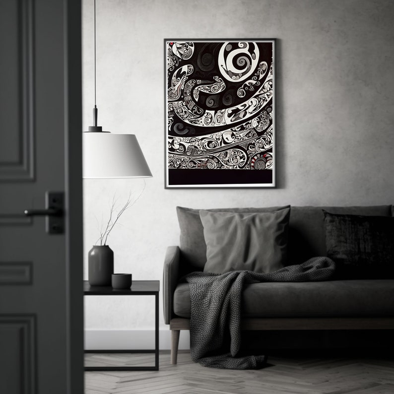 May include: A black and white framed print of an abstract design with swirling patterns. The print is hanging on a gray wall above a gray couch with a throw blanket.