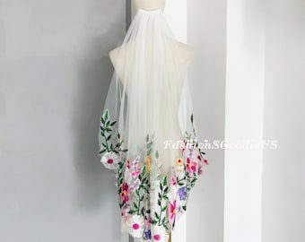 May include: White bridal veil with a floral embroidery design. The embroidery features pink, purple, yellow, and green flowers.