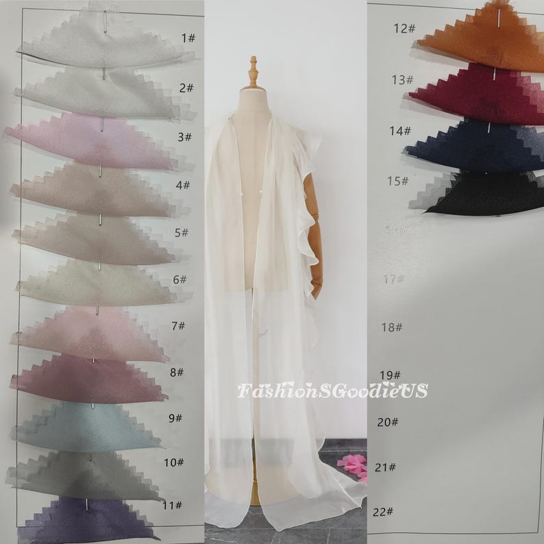 Pu&ograve; includere: Un tessuto bianco trasparente con bordi arricciati, esposto su un manichino. Il tessuto &egrave; mostrato in 22 colori diversi, numerati da 1 a 22. Il testo "FashionSGoodieUS" &egrave; visibile nell'immagine.