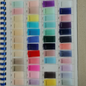 May include: A color chart of 40 different shades of tulle fabric. The chart is organized in rows and columns, with each square containing a different color of tulle. The colors range from light pink to dark blue, with many shades of green, yellow, and red in between.
