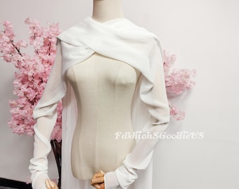 May include: A white, long-sleeved wrap top with a draped neckline and fitted cuffs. The top is displayed on a mannequin with a wooden stand. The text "FashionSGoodieUS" is visible on the garment.