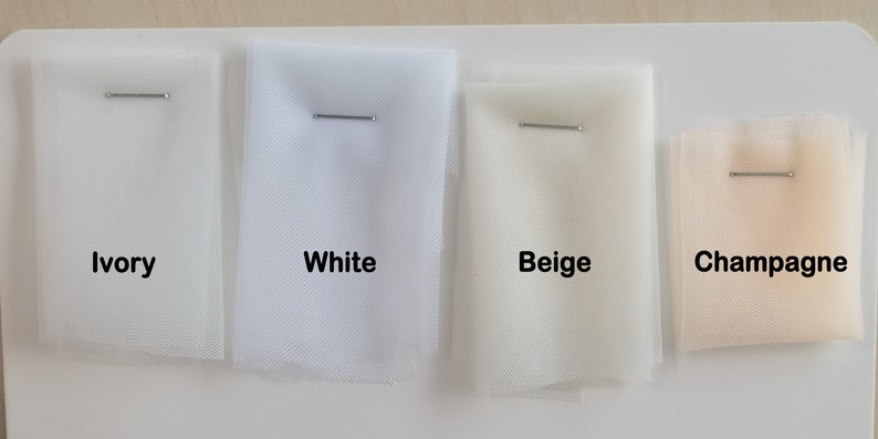 May include: Four swatches of tulle fabric in different colors: ivory, white, beige, and champagne. Each swatch is labeled with its color name.