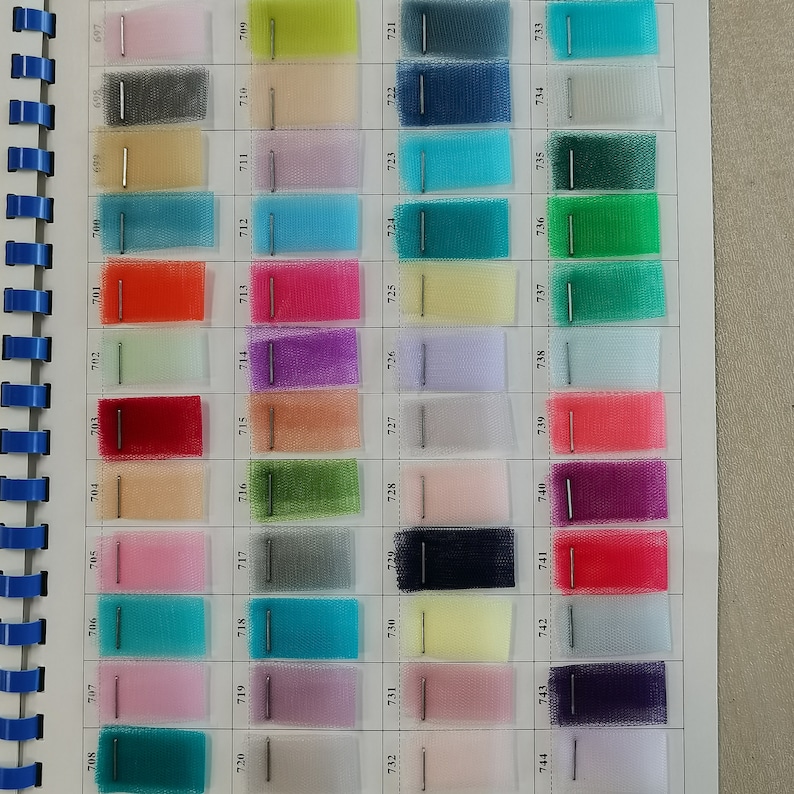 May include: A color chart of 44 different shades of tulle fabric. The chart is numbered from 701 to 744.