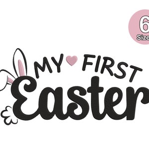 May include: A white background with the text "MY FIRST EASTER" in black script, with a pink heart replacing the "O" in MY. Bunny ears peek out from behind the word "Easter". A pink circle with the number "6" and the word "Sizes" is in the upper right.