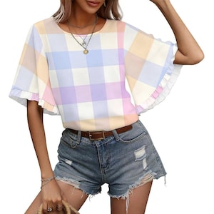 May include: A pastel plaid top with frilled sleeves. The top has a round neckline and a brown belt. The model is wearing denim shorts. The top's colours include pink, yellow, blue, and purple.
