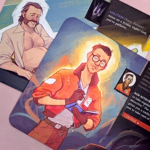 May include: Illustration of game cards featuring character portraits. One card shows a man in an orange jacket writing in a notebook. Another card depicts a man with a mustache. Text on the cards includes "VOLITION" and "KIM KITSURAGI".