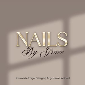 May include: A logo design featuring the word "NAILS" in gold, elegant lettering above "By Grace" in a cursive font. The background is a neutral beige with a shadow effect. Text at the bottom reads "Premade Logo Design | Any Name Added."