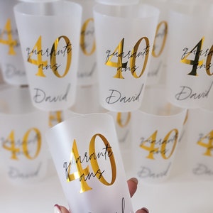 May include: Clear plastic cups with gold lettering that says "quarante ans" and "David".