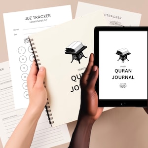 May include: A white journal with the text "mein QURAN JOURNAL" and an illustration of an open Quran on a stand. The journal is being held by a person's hand. A tablet computer is also shown with the same text and illustration on the screen.