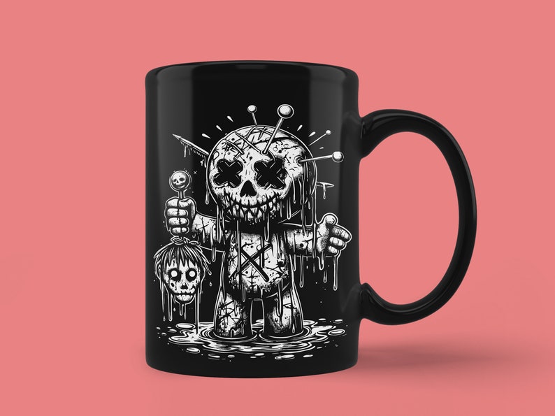 May include: Black ceramic mug with a white illustration of a stitched-up doll with a dripping face and a severed head in its hand. The doll is holding a lollipop in its other hand.