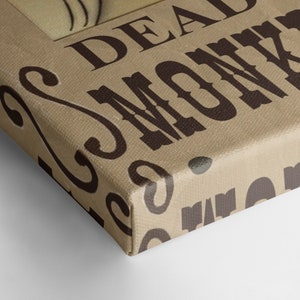 May include: A brown canvas print with the text "Deadwood" and a decorative pattern of swirls. The print has a brown background with black text.