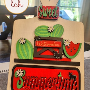 May include: Wooden sign with a red and green watermelon, cactus, and the words "Sweet Watermelon" and "Summertime".