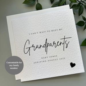 May include: A white card with black text that reads "I can't wait to meet my Grandparents Baby Jones Arriving August 2025". A small black heart is in the bottom right corner.