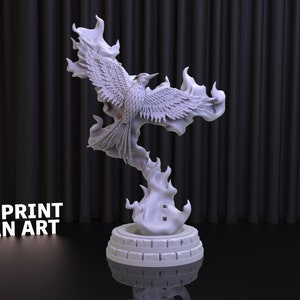 May include: A white 3D printed sculpture of a phoenix rising from flames. The phoenix is detailed with feathers and has its wings spread. The sculpture is on a circular base with a textured surface. The text "3DPRINT FAN ART" is visible in the lower left corner of the image.