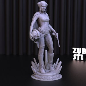 May include: A gray 3D printed figurine of a female character from a science fiction movie. She is wearing a jumpsuit, boots, and a cape. She is holding a helmet in one hand and a blaster in the other. She is standing on a base with a crystal design. The text "ZUBARH STL ART" is visible in the background.