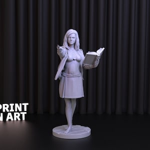 May include: A white 3D printed figurine of a woman holding a book. She is wearing a skirt, a jacket, and a necklace. The figurine is standing on a circular base.