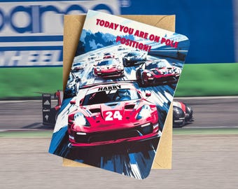 May include: A birthday card featuring a red race car with the number 24 on the side. The card has the text "TODAY YOU ARE ON POLE POSITION!" and the name "HARRY" on the car. The card is surrounded by a brown envelope.