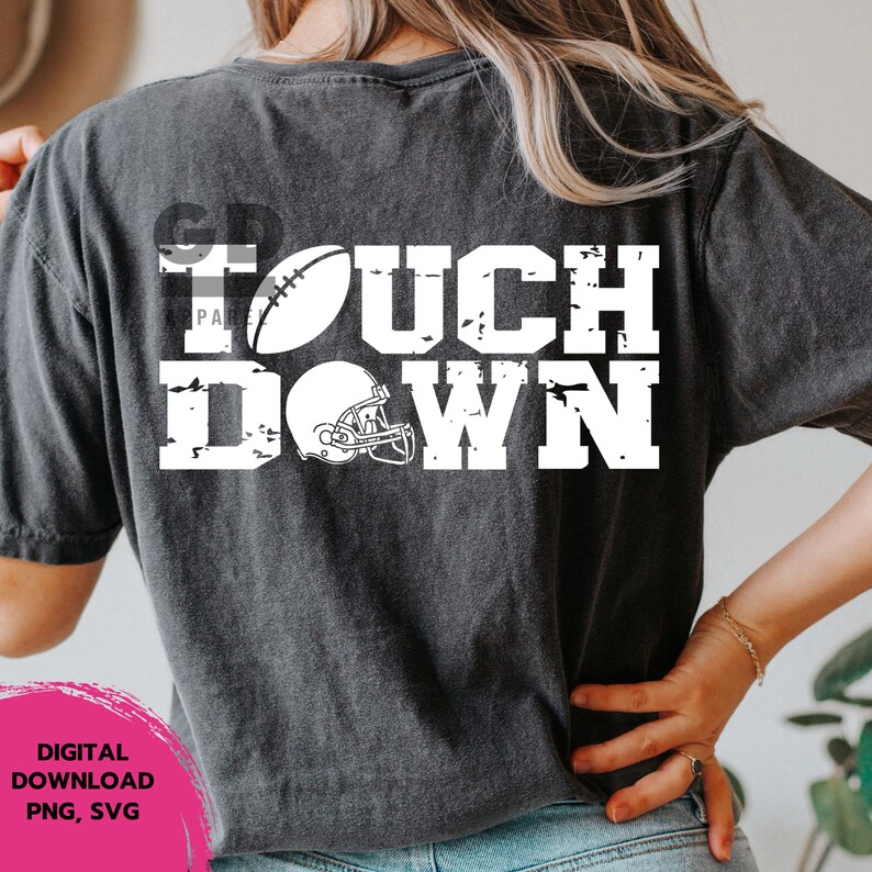 May include: A black t-shirt with a white distressed graphic that says "TOUCHDOWN" with a football and helmet.