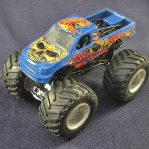 Pair of Hot Wheels Monster Jam Trucks including Blue Thunder & Instigator in good preowned condition.