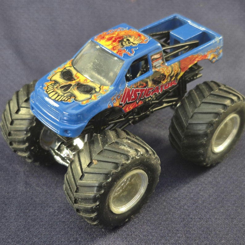 Pair of Hot Wheels Monster Jam Trucks including Blue Thunder & Instigator in good preowned condition.