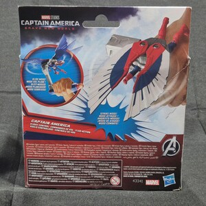 May include: A Captain America Brave New World action figure packaging back panel featuring a red, white, and blue winged character in strike mode, a circular inset showing glide mode, Marvel Studios branding, and multilingual product information text.