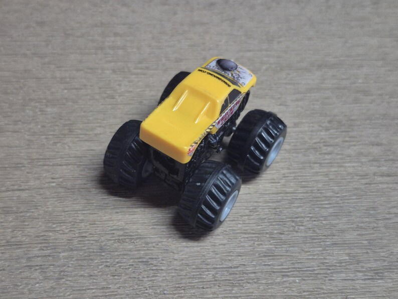 Hot Wheels Mini Monster Truck & Monster Jam Lot.  Includes Hot Wheels Monster Jam Shocker, Yellow body Wrecking Crew, Ford Mustang with flame graphics & Monster Jam El Toro Loco vehicle with pull back friction motor. El Toro is missing a horn, otherwise Lot is in Good Preowned Condition.