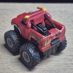 Hot Wheels Mini Monster Truck & Monster Jam Lot.  Includes Hot Wheels Monster Jam Shocker, Yellow body Wrecking Crew, Ford Mustang with flame graphics & Monster Jam El Toro Loco vehicle with pull back friction motor. El Toro is missing a horn, otherwise Lot is in Good Preowned Condition.