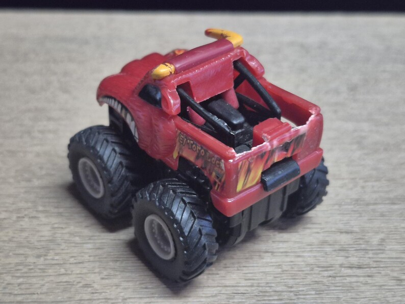 Hot Wheels Mini Monster Truck & Monster Jam Lot.  Includes Hot Wheels Monster Jam Shocker, Yellow body Wrecking Crew, Ford Mustang with flame graphics & Monster Jam El Toro Loco vehicle with pull back friction motor. El Toro is missing a horn, otherwise Lot is in Good Preowned Condition.