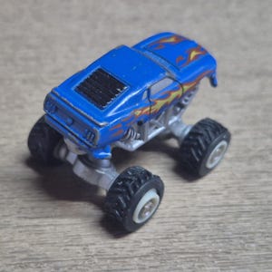 Hot Wheels Mini Monster Truck & Monster Jam Lot.  Includes Hot Wheels Monster Jam Shocker, Yellow body Wrecking Crew, Ford Mustang with flame graphics & Monster Jam El Toro Loco vehicle with pull back friction motor. El Toro is missing a horn, otherwise Lot is in Good Preowned Condition.