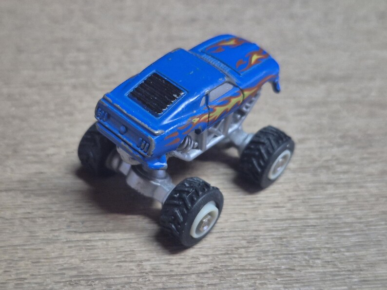Hot Wheels Mini Monster Truck & Monster Jam Lot.  Includes Hot Wheels Monster Jam Shocker, Yellow body Wrecking Crew, Ford Mustang with flame graphics & Monster Jam El Toro Loco vehicle with pull back friction motor. El Toro is missing a horn, otherwise Lot is in Good Preowned Condition.