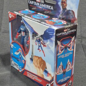May include: A Marvel Studios Captain America Brave New World action figure in its original packaging. The box features a blue and red Captain America figure with wings, flight control accessories, and graphics showing flight and strike modes.