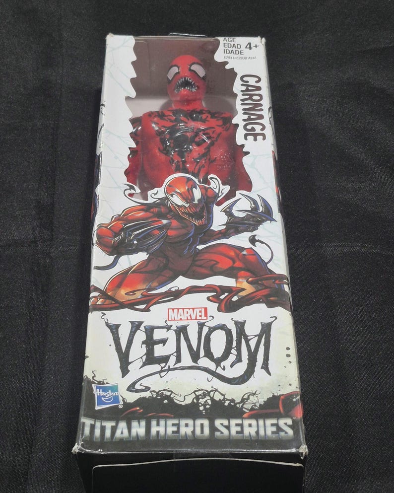 May include: A Carnage action figure from the Marvel Venom Titan Hero Series in its original packaging. The box features a red and black character illustration, the text Carnage, Marvel Venom, and Titan Hero Series, with an age rating of 4+.