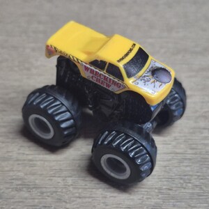 A yellow and black toy monster truck with large black tires. The truck has the words "WRECKING CREW" on the side and the website "BANGING.COM" on the roof.