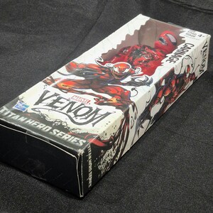 May include: A Marvel Venom Titan Hero Series Carnage action figure inside a rectangular cardboard box with a clear plastic window. The packaging features red and black character illustrations, the name Carnage, and the Hasbro logo on the front.