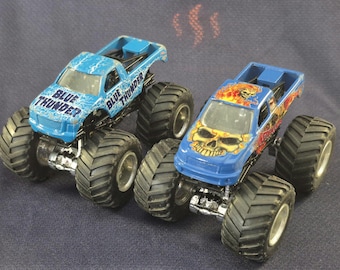 Hot Wheels Monster Truck Jam Lot Blue Thunder & Instigator Lightening Bolts and Flaming Skull Diecast Toy Trucks Vehicles