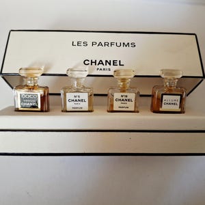 Chanel, a titled and branded gift box containing 4 miniature perfume extracts: Allure, Coco Mademoiselle, Number 5 and Number 19
