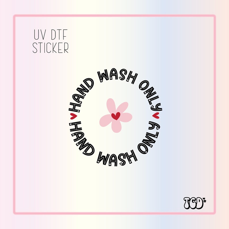 May include: A black and white sticker with a pink flower and the text "HAND WASH ONLY" repeated twice in a circle. The sticker is labeled "UV DTF STICKER".