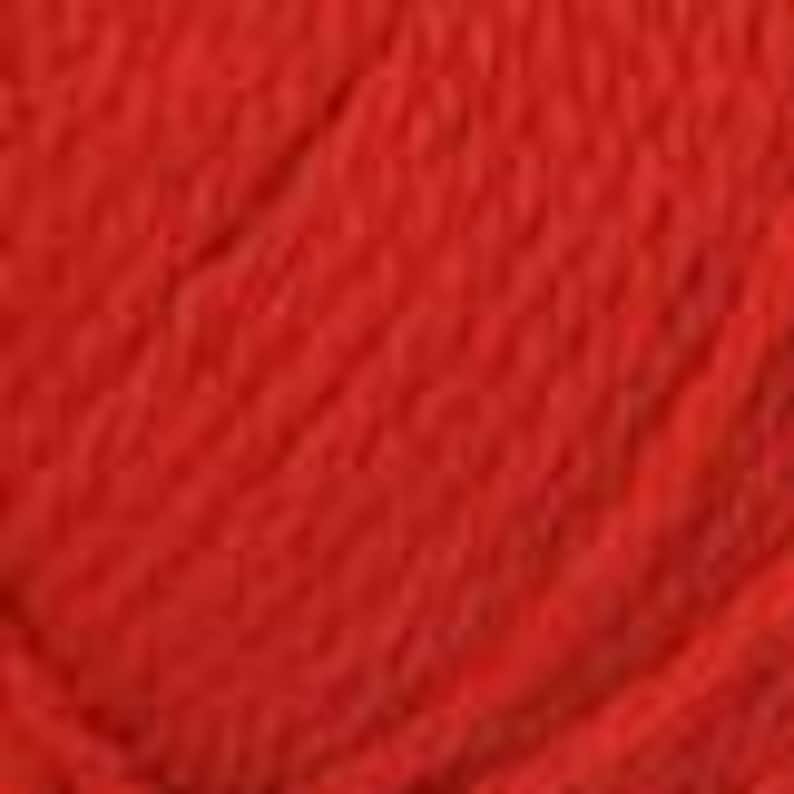 May include: Close-up of a vibrant red ball of yarn. The yarn appears to be a soft, textured material, possibly wool or a wool blend. The image highlights the rich colour and the woven structure of the yarn, suitable for knitting or crocheting projects.