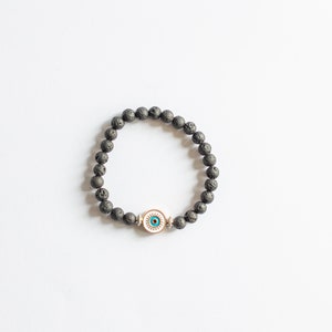 May include: Black lava rock beaded bracelet with a blue evil eye charm.