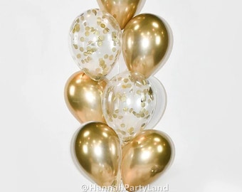 Puede incluir: Un ramo de globos dorados y transparentes con confeti dorado en su interior. Los globos están atados con una cinta dorada.