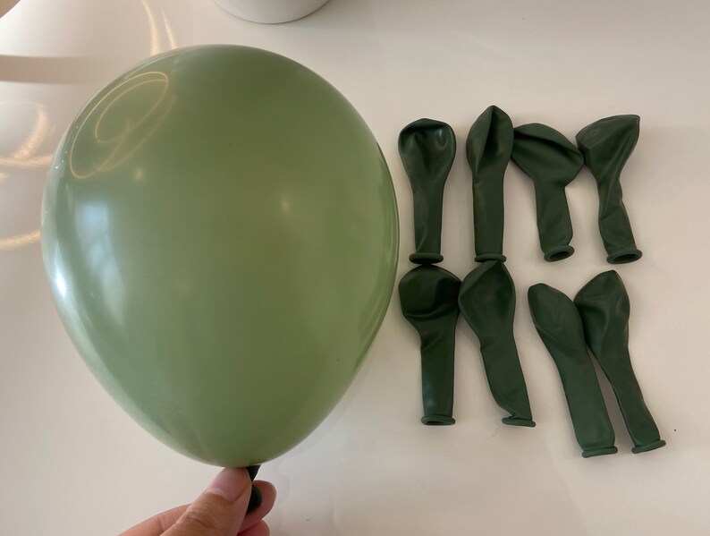 May include: A set of 10 sage green latex balloons. The balloons are deflated and ready to be inflated. The balloons are perfect for a party or celebration.