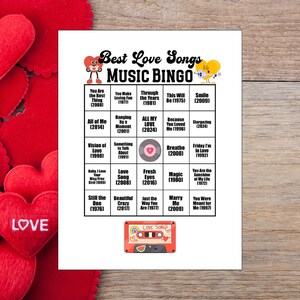 May include: A white Best Love Songs Music Bingo game card with song titles and years, featuring heart graphics. A red cassette tape graphic with the words "Love Songs" is at the bottom. Red heart decorations are in the background.
